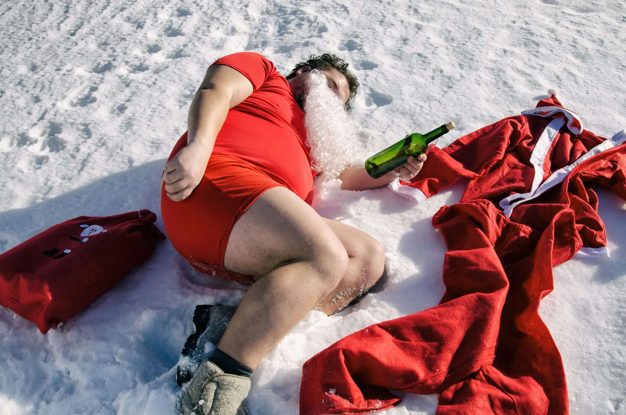 Photograph of a fake Santa Claus drunk on the ground