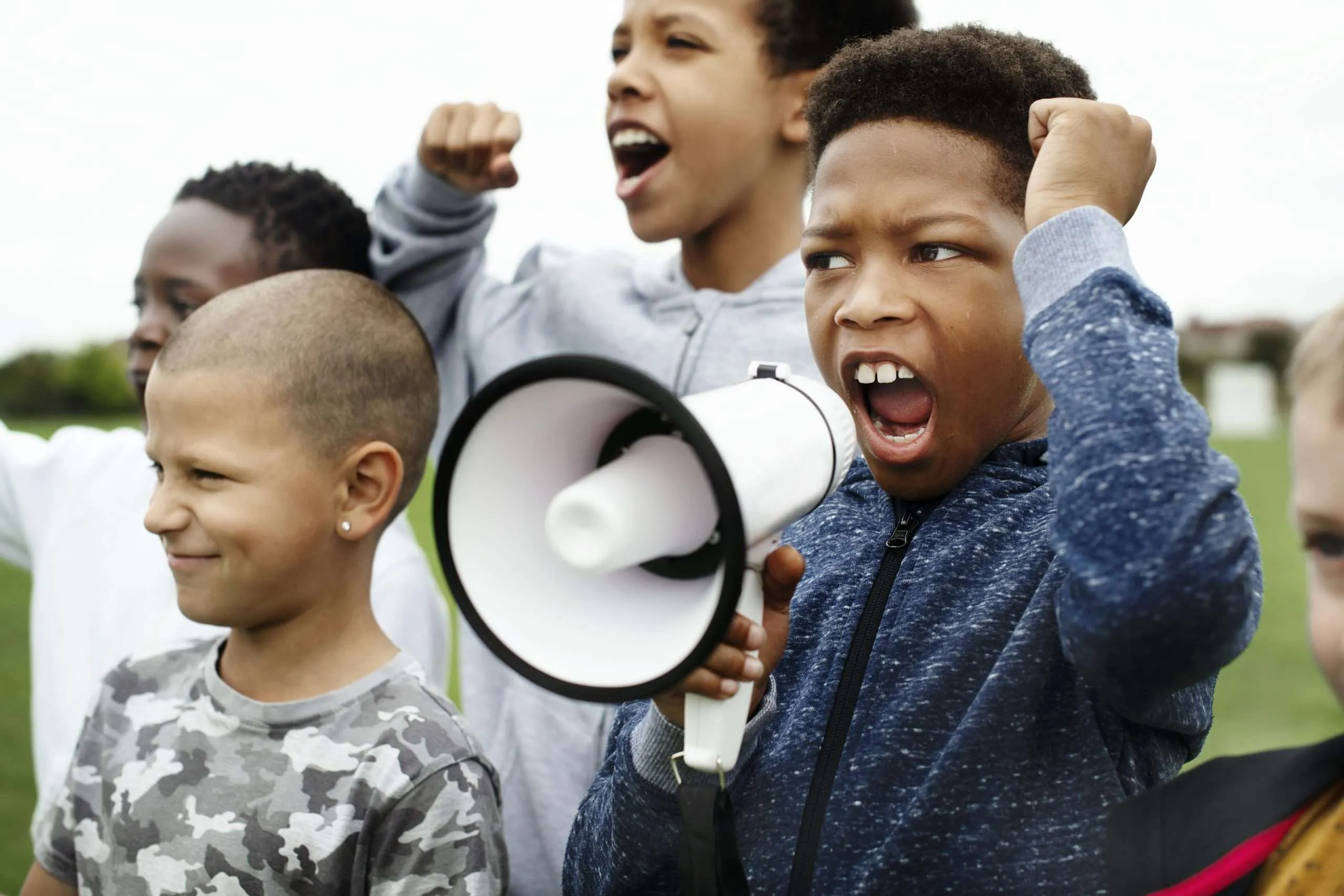 Young Boy Shouting on a Megaphone in a Protest