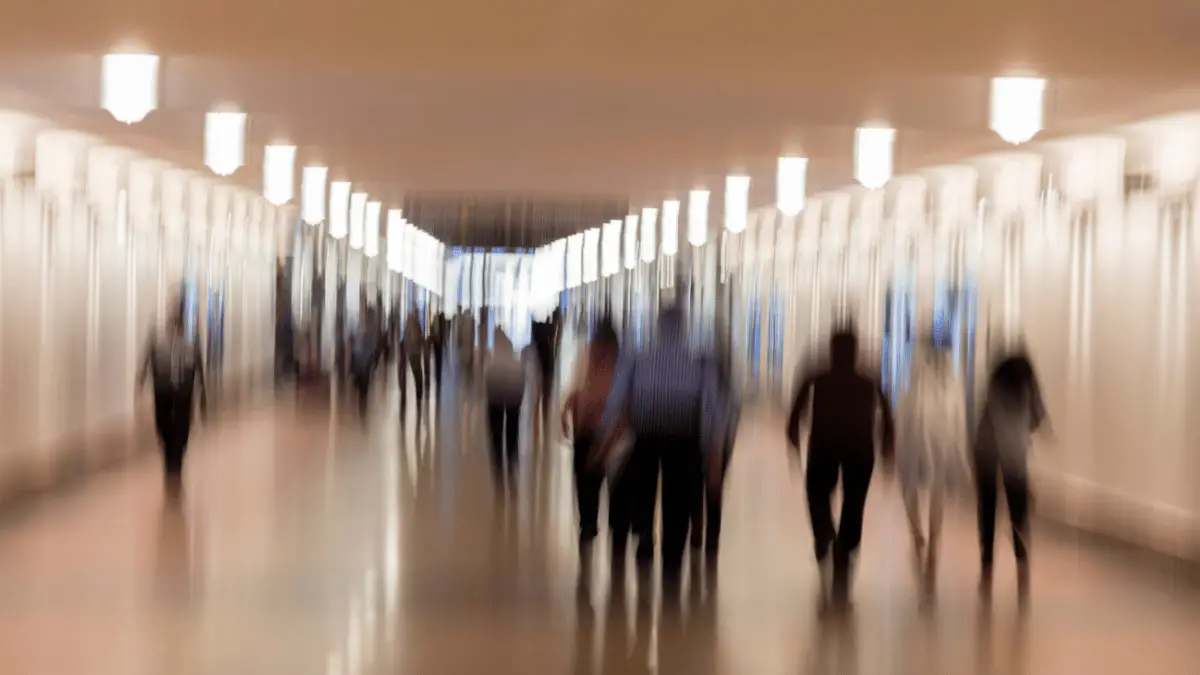 Blurred Photo of People Moving About in a Well Lit Hallway for Essay Titled Why is Sociology Important? One Sociology Honors Student's Perspective