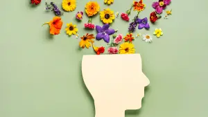 Image of a Human Head Made of Paper with Flowers Emerging Upward from the Top.