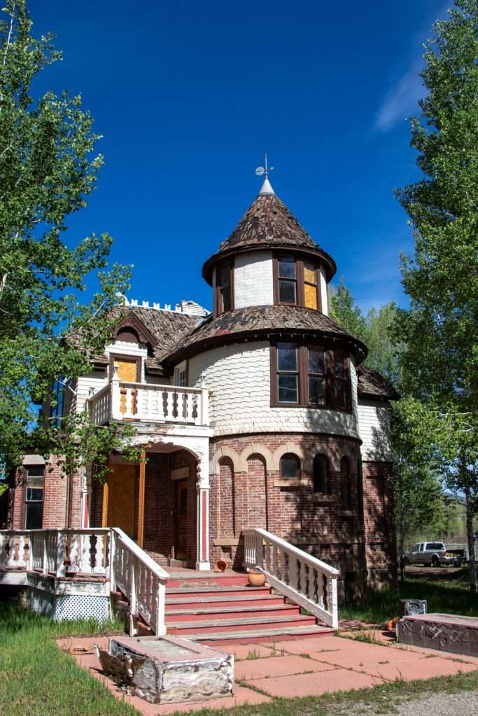 Photo of Hartman Castle surrounded by lush aspen trees for Applied Worldwide blog "Hartman Castle, Historic Preservation and Sociology of Place"